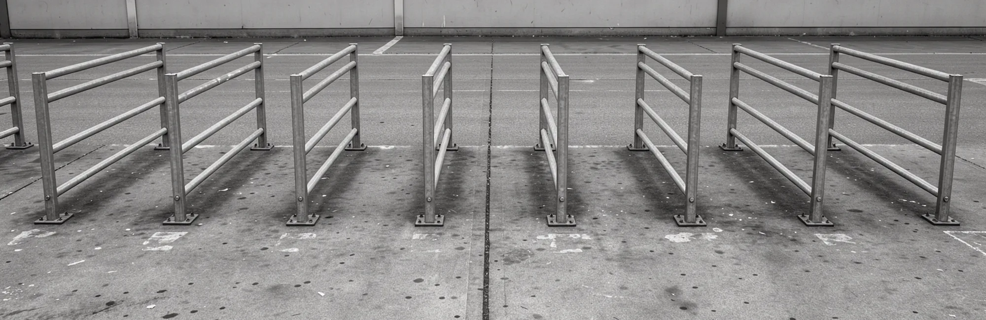 An empty supermarket trolley corral made of plain metal rails.